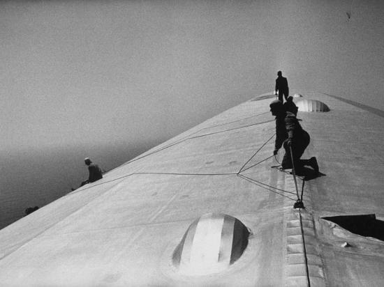 Maintenance Crewmen on Top of Graf Zeppelin repair damage caused Atlantic Ocean Storm during flight