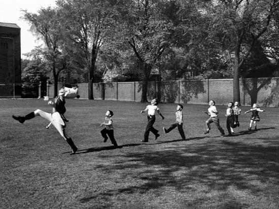 Uniformed Drum Major For University of Michigan Marching Band Practicing His High Kicking Prance