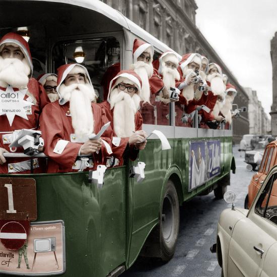 100 Santa Claus in a Special Bus in Paris December, 19, 1966. Colorized Document